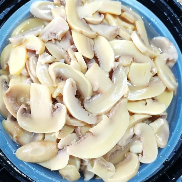 Sliced white mushroom in salted water